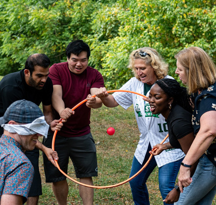 a group of people playing with a hoop