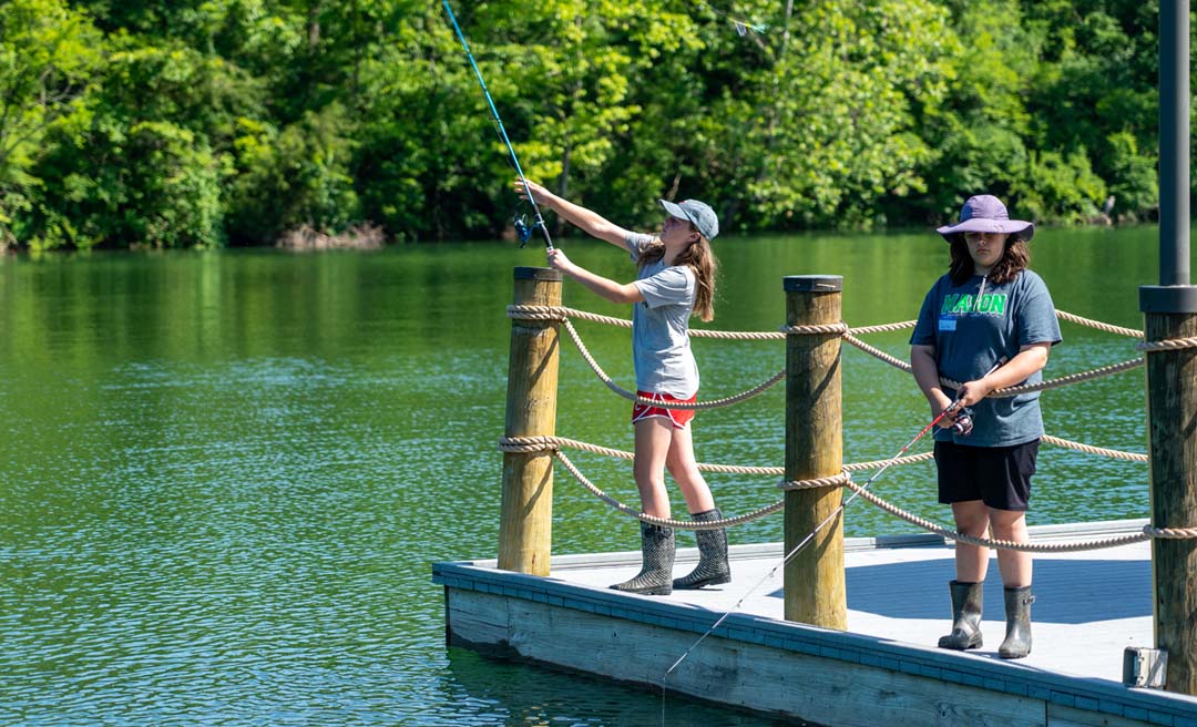 a group of people fishing on a dock