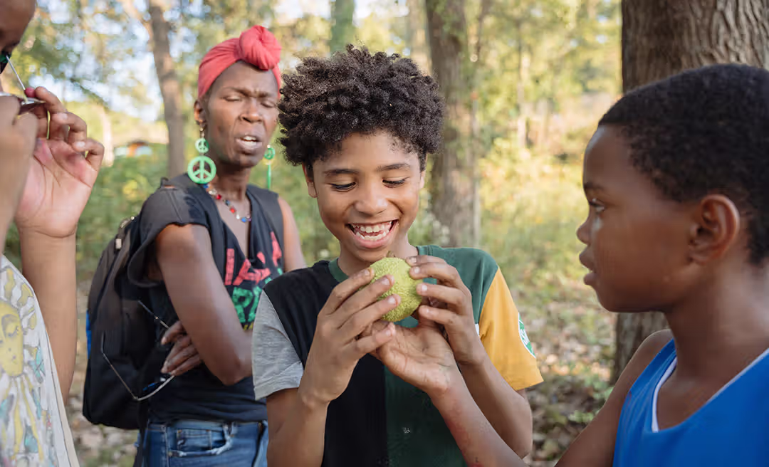 a group of people standing in the woods
