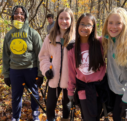 a group of girls standing in a forest