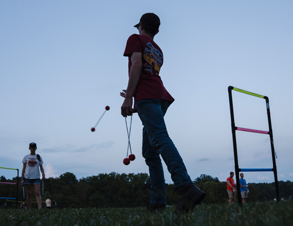 a person in a red shirt juggling balls