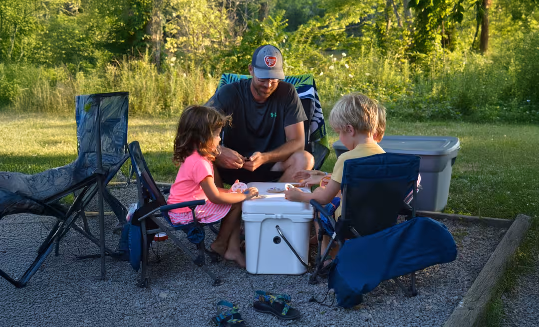 a man and children sitting outside