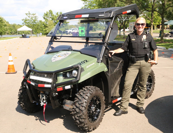 a woman standing next to a vehicle