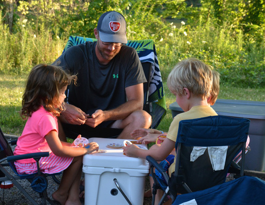 a man and children sitting outside