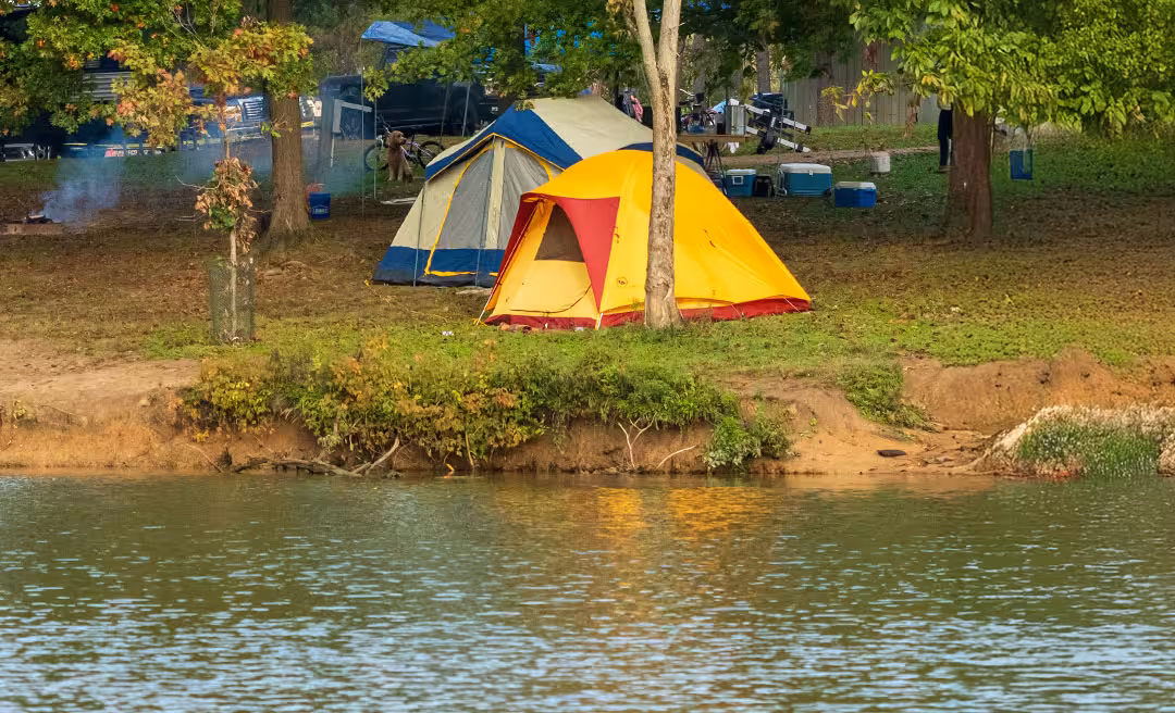 a group of tents next to a body of water