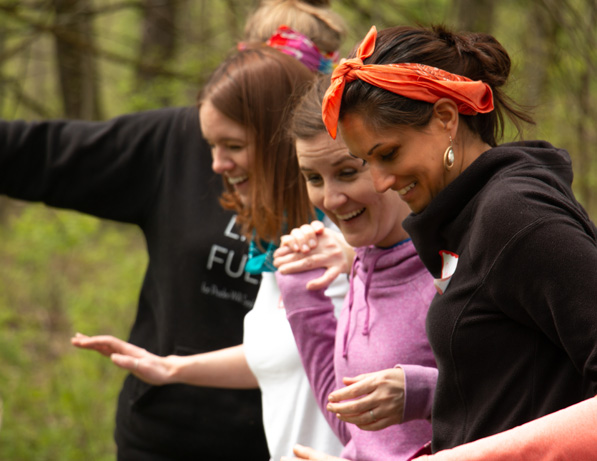 a group of women in the woods