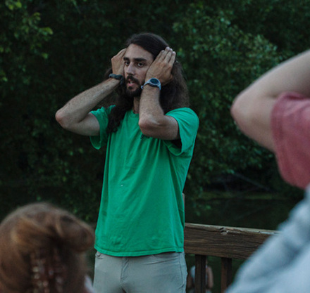 a man with his hands on his ears