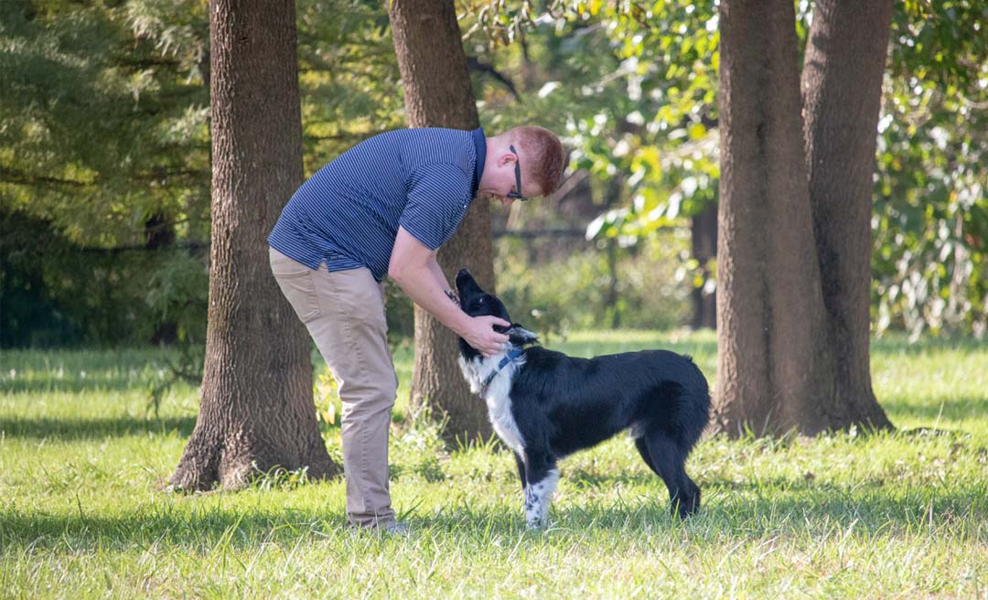 a man petting a dog