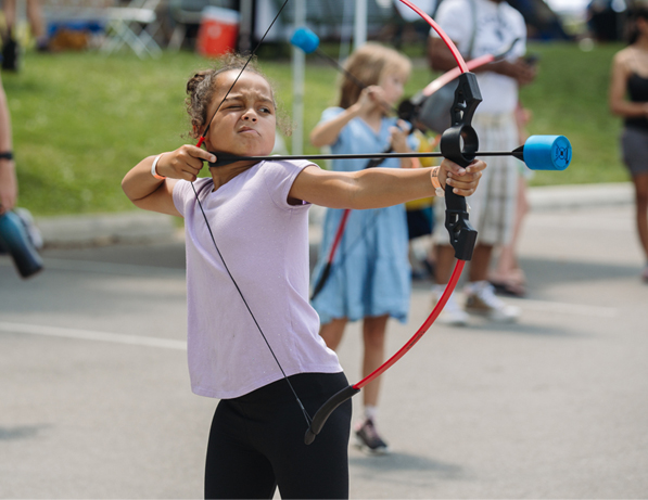 a girl shooting a bow and arrow