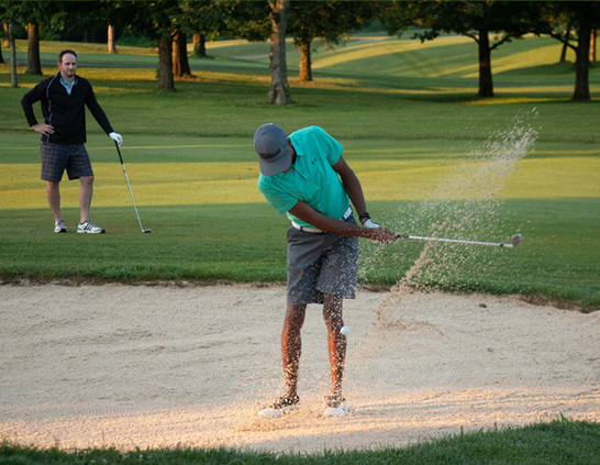 a man swinging a golf club