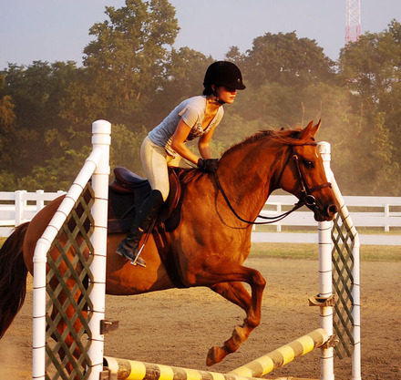 a woman riding a horse