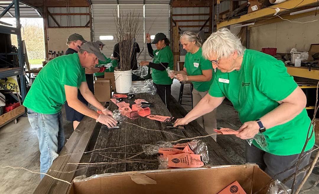 a group of people in green shirts