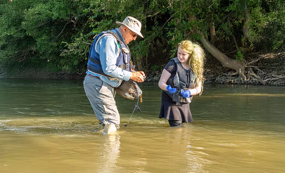 a man and woman standing in water