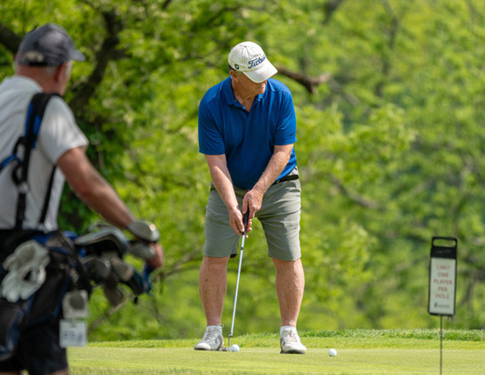 a man playing golf on a golf course