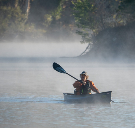 a person in a boat on a lake