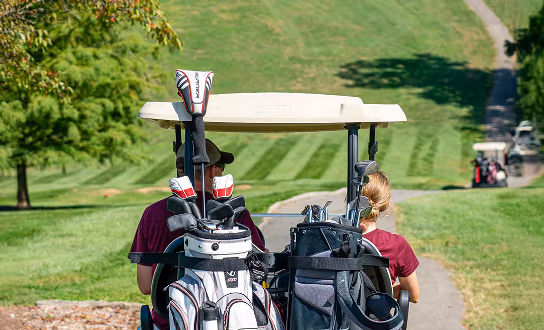 a group of people in golf carts