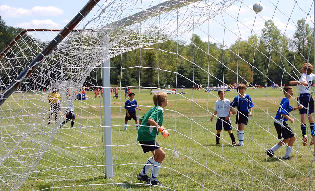 Goalie and net at a soccer match.