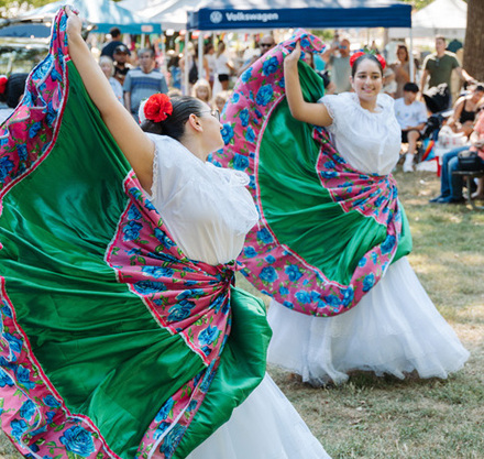 a group of women dancing in a field