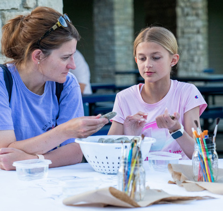 a woman and a girl sitting at a table