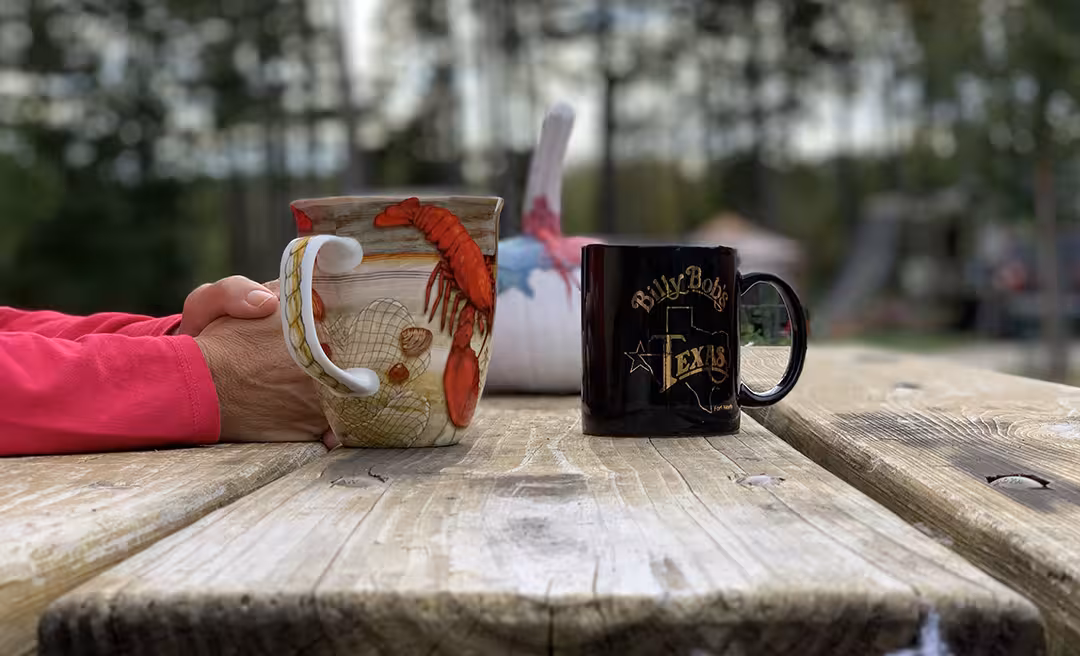 a hand holding a mug