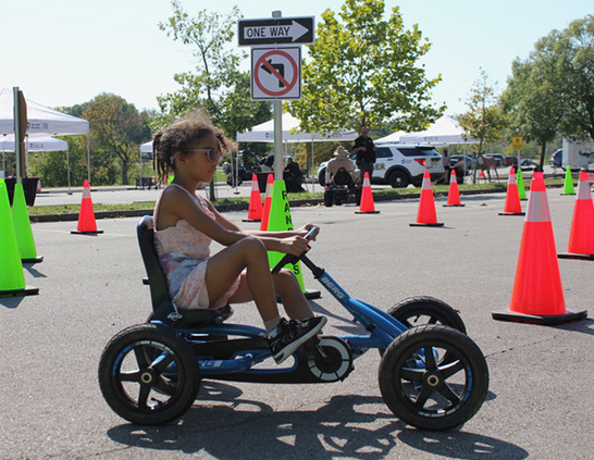 a girl riding a tricycle