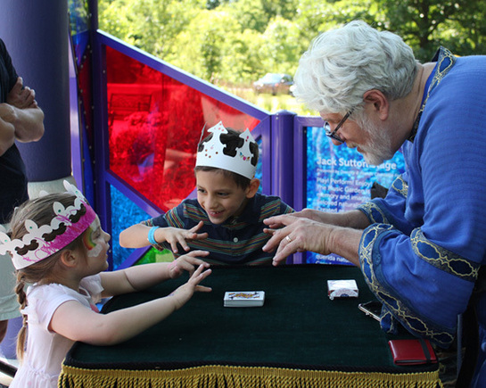 a man and two children playing cards