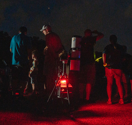 a group of people standing around a red light