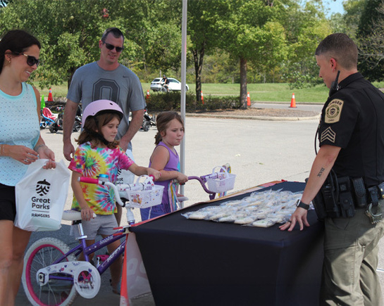 a police officer standing next to a table with small fish