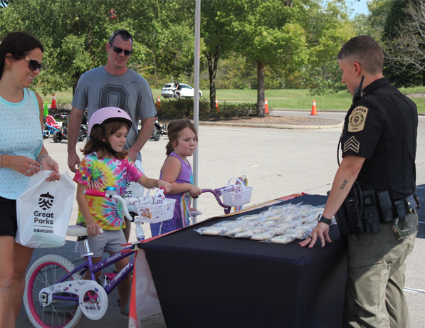 a police officer standing next to a table with small fish