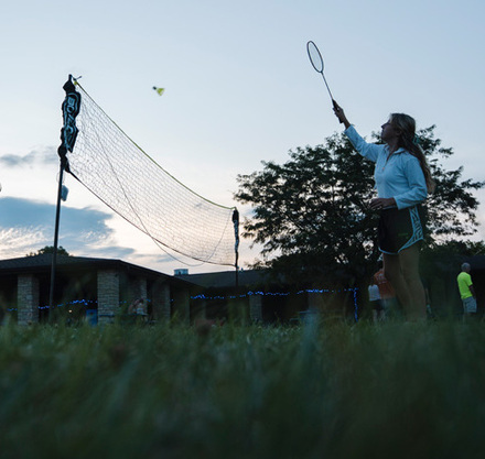 a couple of people playing badminton