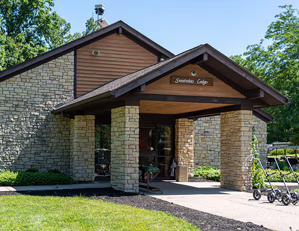 a building with a stone wall and a stone walkway