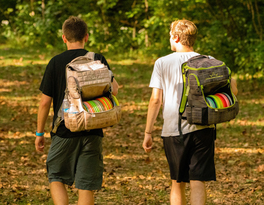two boys walking with backpacks