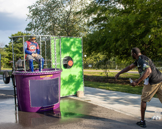 a man in a garment sitting on a purple round object