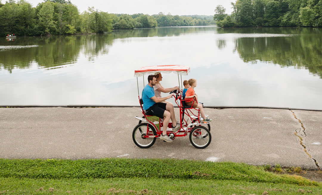 a man and two children riding a bicycle