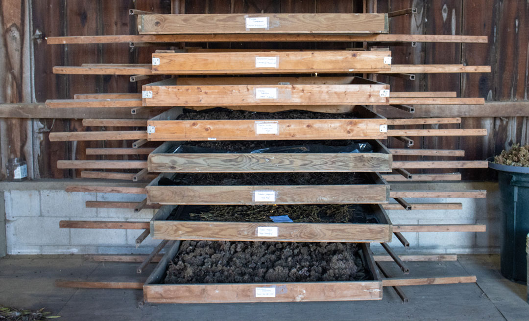 a stack of wooden shelves with dirt inside